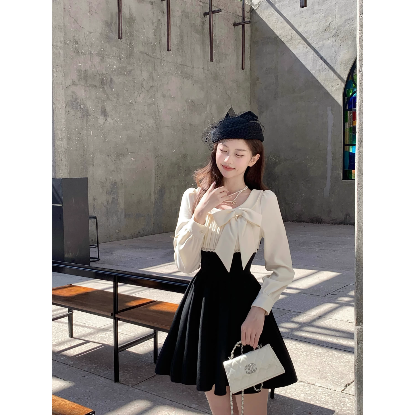 Black dress with a fitted waist, short skirt, and long sleeves A42